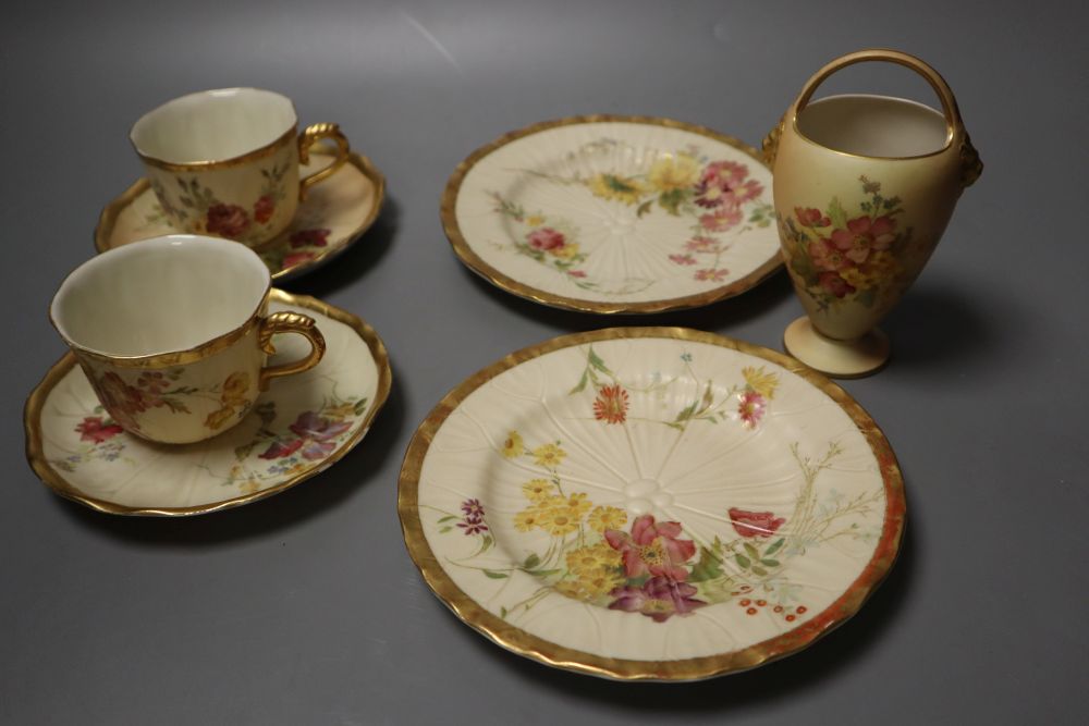 A Royal Worcester over-handled vase painted with flower on a blush ivory ground and two Royal Worcester cups, saucers and side plates